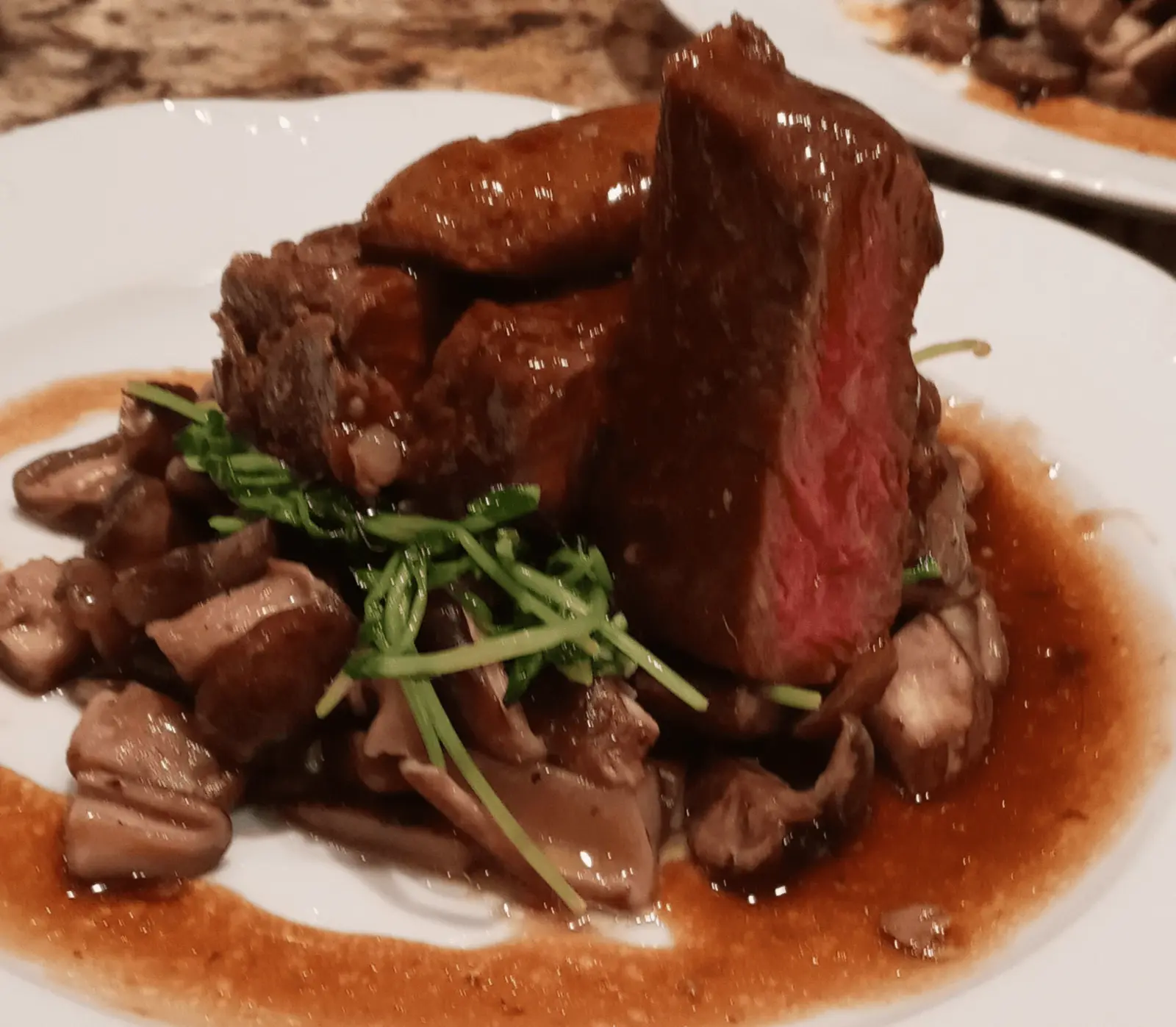 Beef Wellington with mushrooms, herbs and a rich brown sauce.
