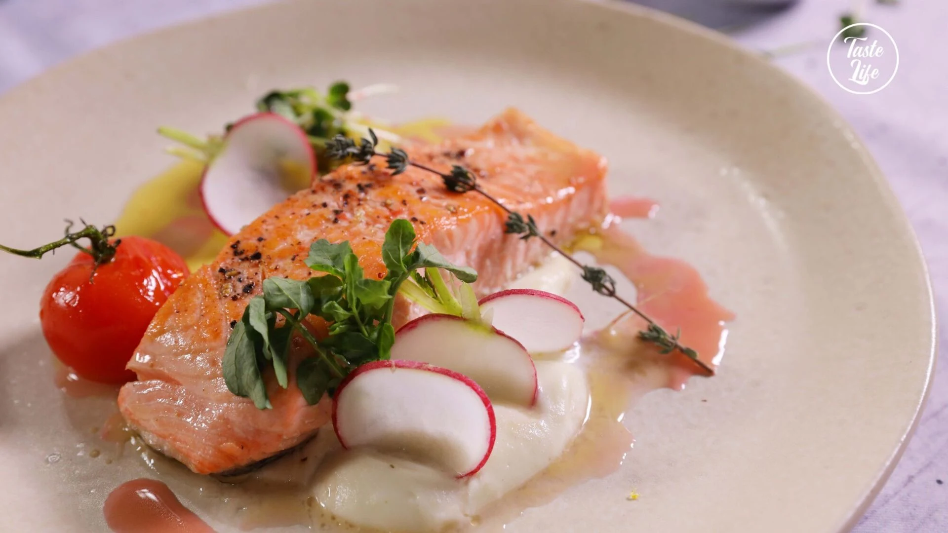 Salmon with sliced radishes, fresh herbs and microgreens.