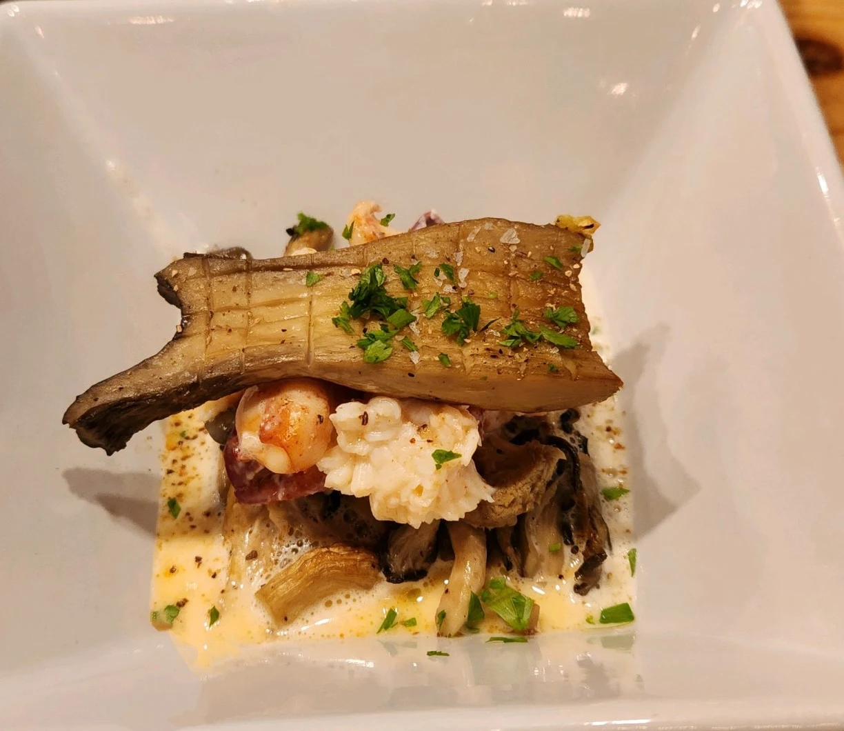 Lobster and mushrooms beneath a long roasted mushroom slice.