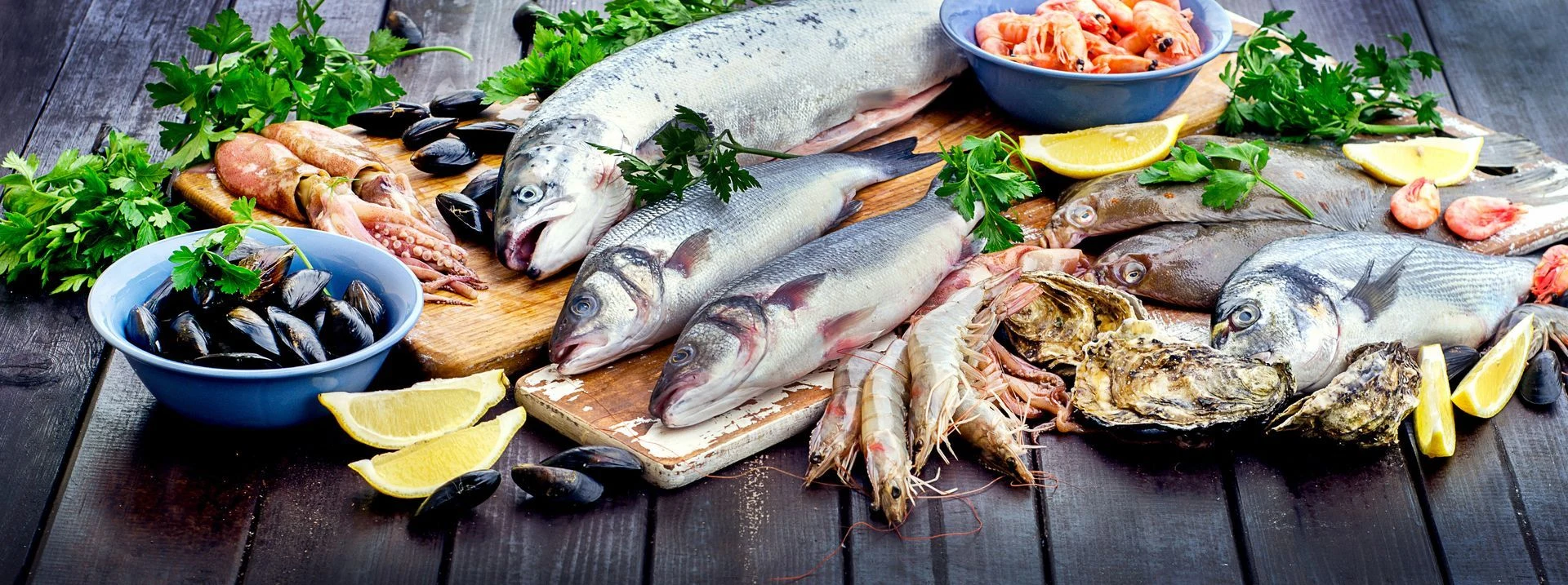 An assortment of fresh whole fish, shellfish and shrimp with lemon and herbs.